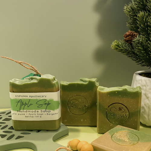 Green Apple handmade soap bars by Espuma Apothecary displayed on a light green surface with subtle decorative accents.