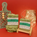 Brisa handmade soap by Espuma Apothecary displayed in soft green bars on a red background with subtle decorative accents.